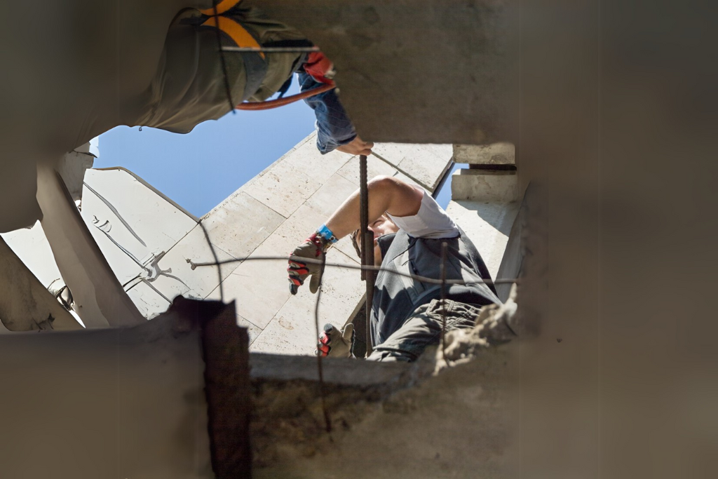 Technician applying shotcrete for culvert rehabilitation to ensure long-lasting performance and durability in harsh environments using non-invasive pipe repair methods.